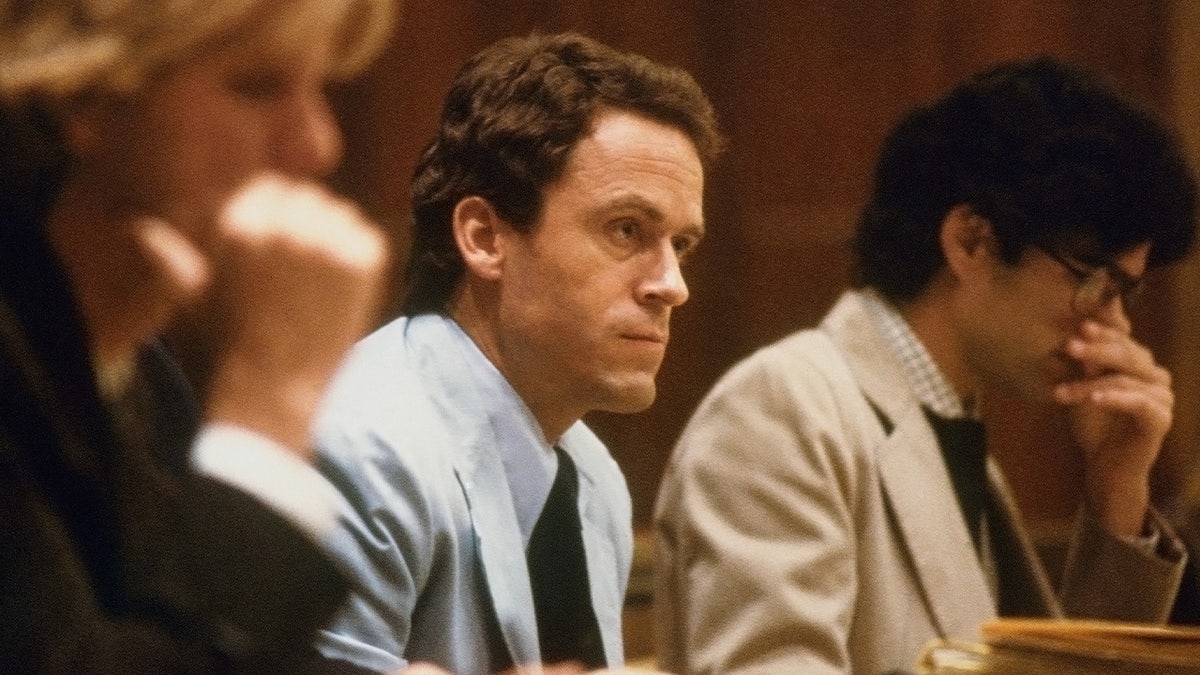 Theodore Bundy in a blue suit sitting in court