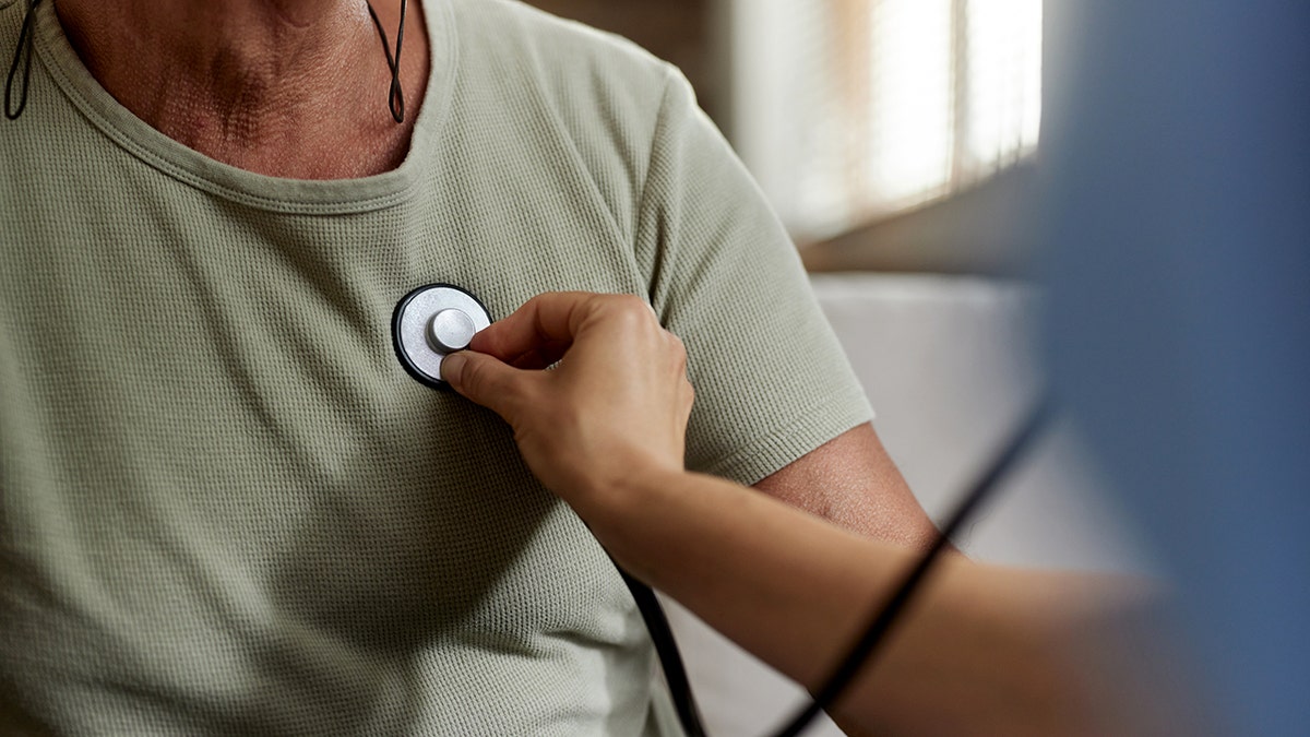 Doctor listening to patient's heart