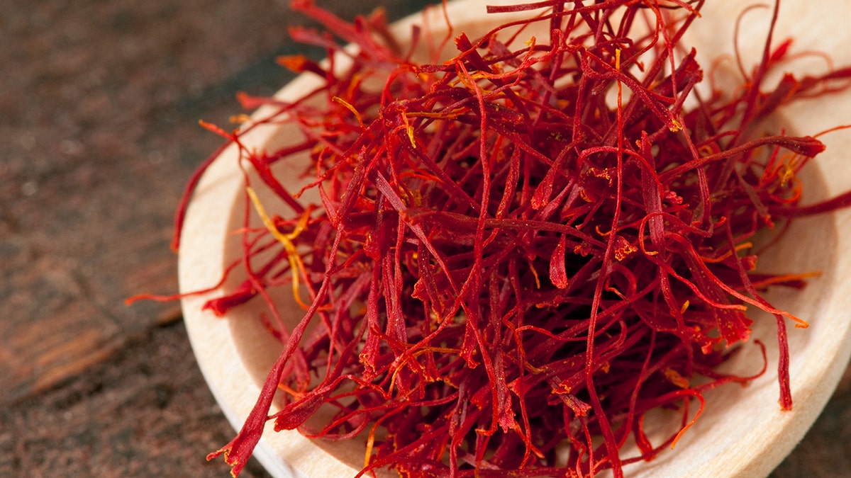 red saffron on a wooden spoon