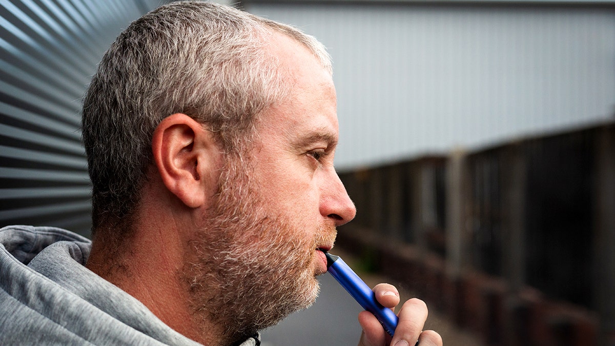 Man vaping, side view
