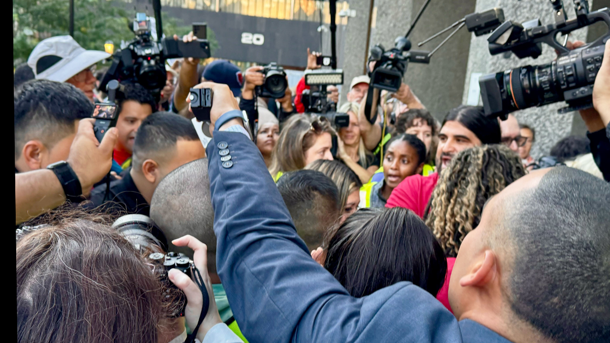 Kilmar Abrego Garcia, his wife, and his lawyer are mobbed by supporters and journalists as he appears at the ICE Field Office in Baltimore. His lawyer said he was arrested by ICE and that they will remove him to a third country, prompting them to file an emergency lawsuit in Maryland. (Breanne Deppisch/Fox News Digital)