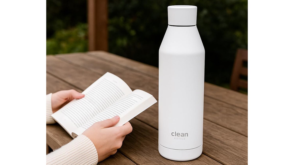 Clean Hydration Co, Canteen in white next to a woman reading a book