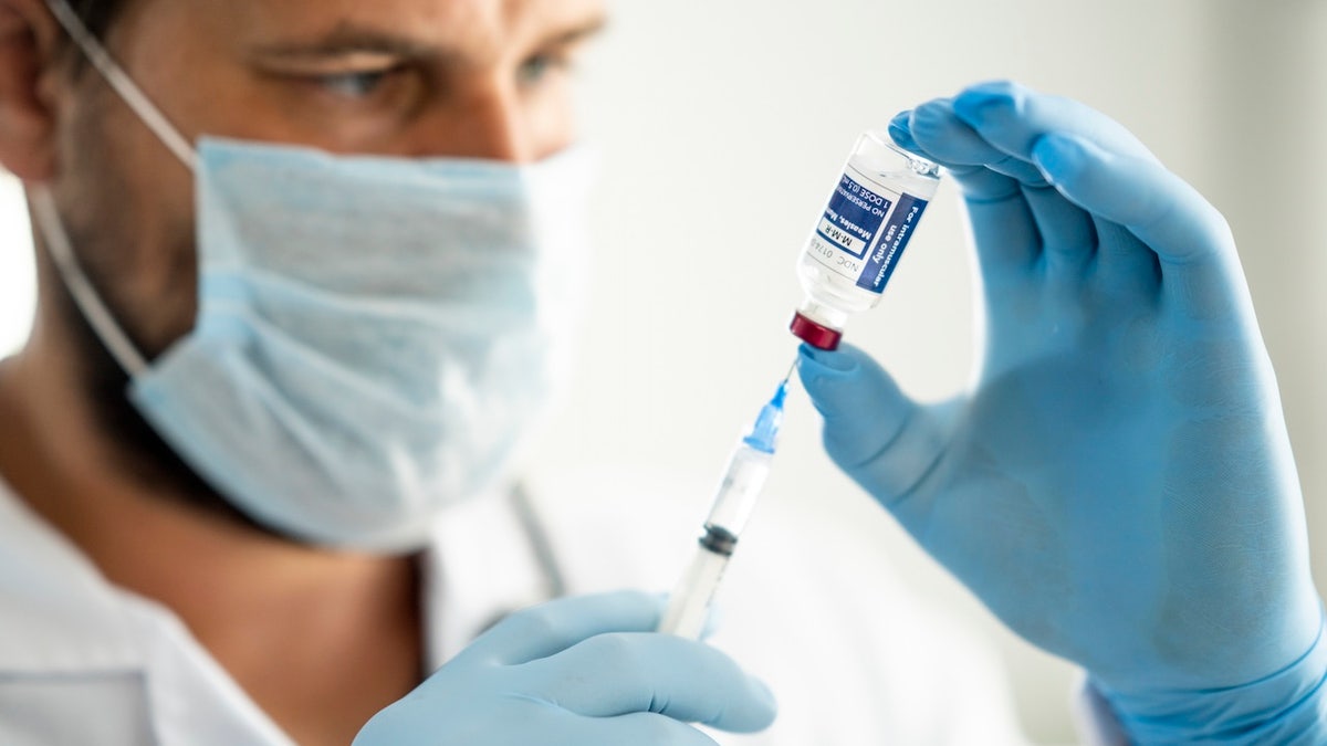 Doctor preparing MMR vaccine